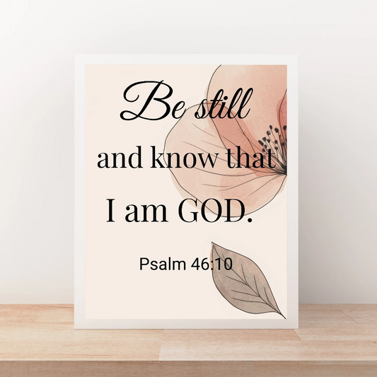 Framed print with motivational quote 'Be still and know that I am GOD' and Psalm 46:10 on a light background.